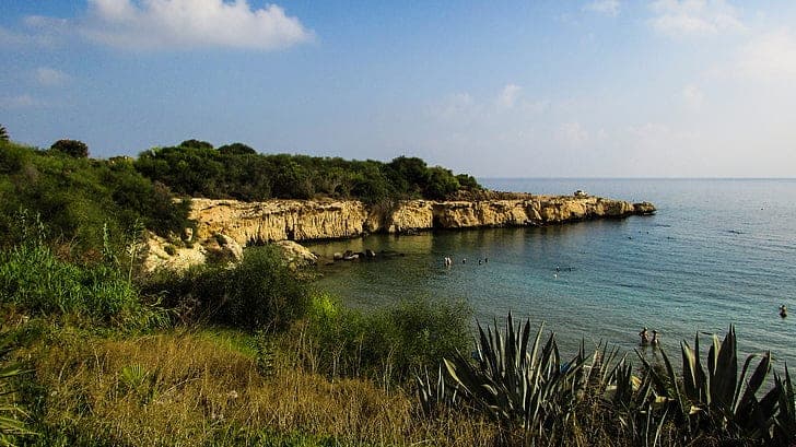 Malama Beach (Skoutarospilioi), a sandy cove with cliffs in Kapparis, Cyprus